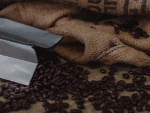 bag laying on side with coffee beans spilling out